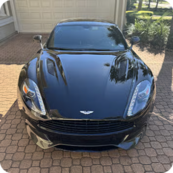 Figure → Aston Martin receiving exterior detailing with gloss polish, and premium wax protection.
